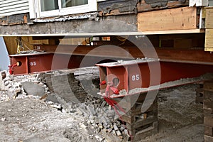 Old house resting on girders and timbers