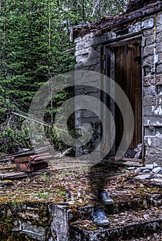 Old house with a sprit standing in a pair of shoes