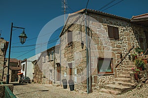 Old house with stone staircase and flower pots