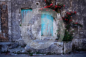 Old house wall and window with flowers