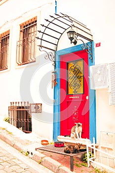 Old house white wall with blue and red door