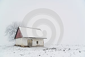 Old house on winter field