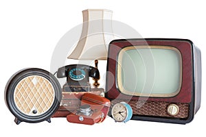 Old household items: TV, radio, camera, alarm, phone, table lamp