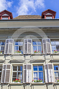 Old houses in Bern. Houses with flowers on the windows. Architecture