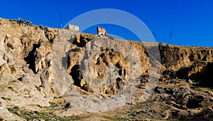 Old houses carved amid the mountains in the city Fez Morocco