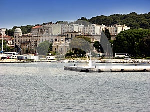 Old houses and coastline in Pula from sea view