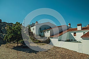 Old houses in front of little square over rocks in Marvao