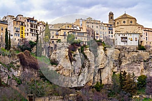 Old houses hanging over the rock ravine of the old city of Cuenca