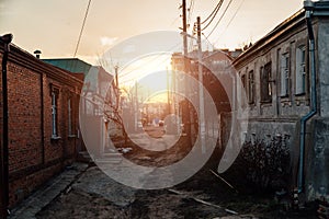 Old houses on low-rise street in old poverty part of Voronezh city in Russia in sunset