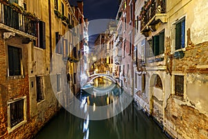 Old houses in the small canal`s of Venice at night