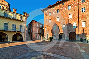 Old houses on small cobblestone square in Alba, Italy.