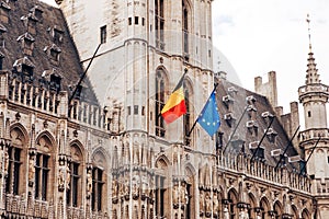 Old houses and square of city Brussels in Belgium, flags European Union