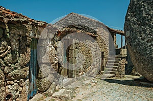 Old houses with stone wall and big round rock in Monsanto