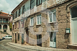 Old houses with stone wall in a deserted alley