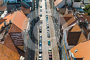 Old houses, street and parked car view from above