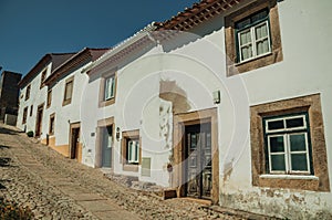 Old houses with whitewashed wall in an alley of Marvao