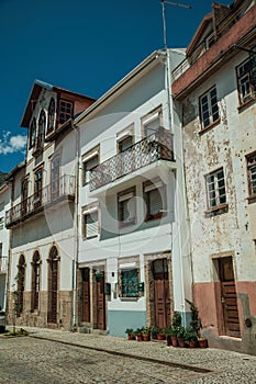 Old houses with worn plaster and wooden doors