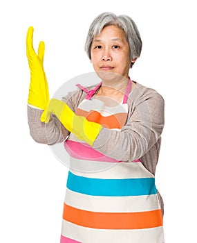 Old housewife wear with plastic gloves