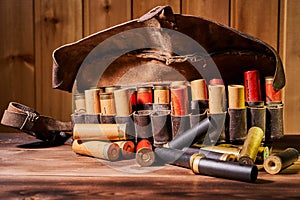 Old hunting cartridges and bandoleer on a wooden table