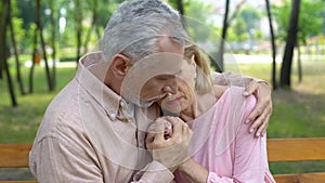 Old husband embracing ill wife, love until old age, support, care, togetherness photo