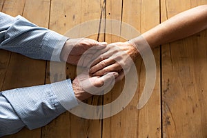 Old husband holding hand of wife showing protection and love