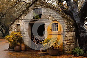 an old hut or barn made of stone against the background of beautiful autumn nature, cozy, a cart wheel in front of it