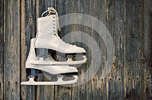 Old ice skates on wooden wall