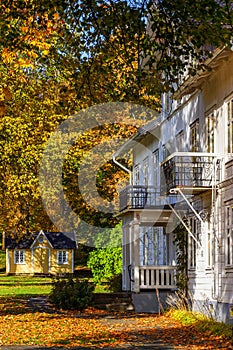 Old idyllic wooden house in a park in autumn