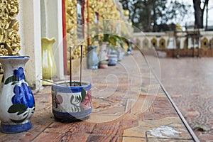 Old incense burner on the tile ground.Belief or ignorant of thailand is worship dead man\'s bone and soul.Honor and reminisce photo