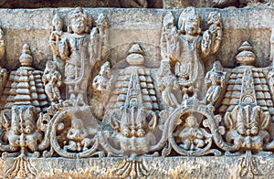 Old Indian architecture background on traditional style relief, with fantasy animals, temple in Halebidu, India.