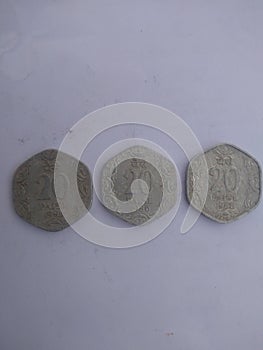 Old indian coin for twety paises with different years photo