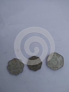 Old indian coinsfor two and three paises with white black round photo