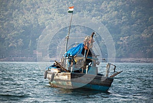 An old Indian fishing boat. The ship sails on the sea in search of fish