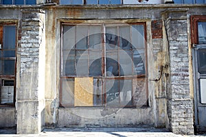 Old industrial building with broken glass window