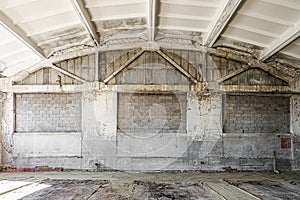 Old industrial building with wet, mold damaged reinforced concrete building structures of workshop