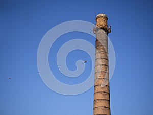 An old industrial chimney against a blue sky