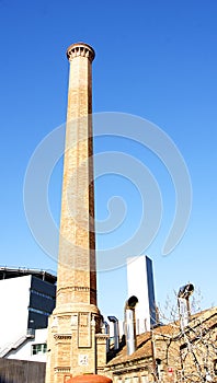 Old industrial chimney in the hospital compound of the Hospital de la Santa Cruz y San Pablo in Barcelona