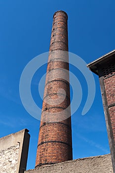 Old industrial chimney in red brick