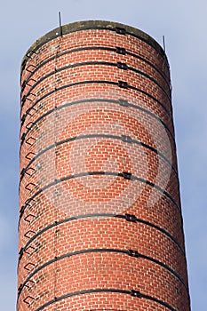 Old industrial chimney of red bricks