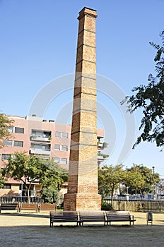 Old industrial chimney in a square in Badalona, Barcelona