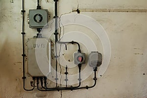 Old industrial electric plug, fuse box and switch on the vintage wall
