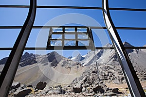 Old Industrial iron window frame and mountains, Argentina