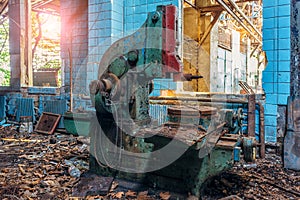 Old industrial machine tool in workshop. Rusty metal equipment in abandoned factory