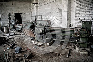 Old industrial machine tools and rusty metal equipment in abandoned factory