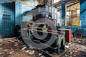 Old industrial machine tools in workshop. Rusty metal equipment in abandoned factory