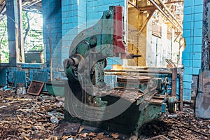 Old industrial machine tools in workshop. Rusty metal equipment in abandoned factory