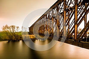 Old industrial railway railroad iron bridge in the night