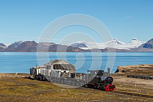 Old industrial train in Ny Alesund, Spitzbergen, Svalbard, blue