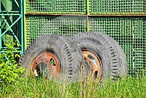 Old industrial truck wheel on wasteland