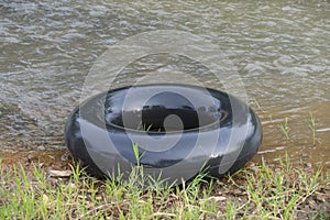 an old inner tube or pile of car tire buoys for play water on beach